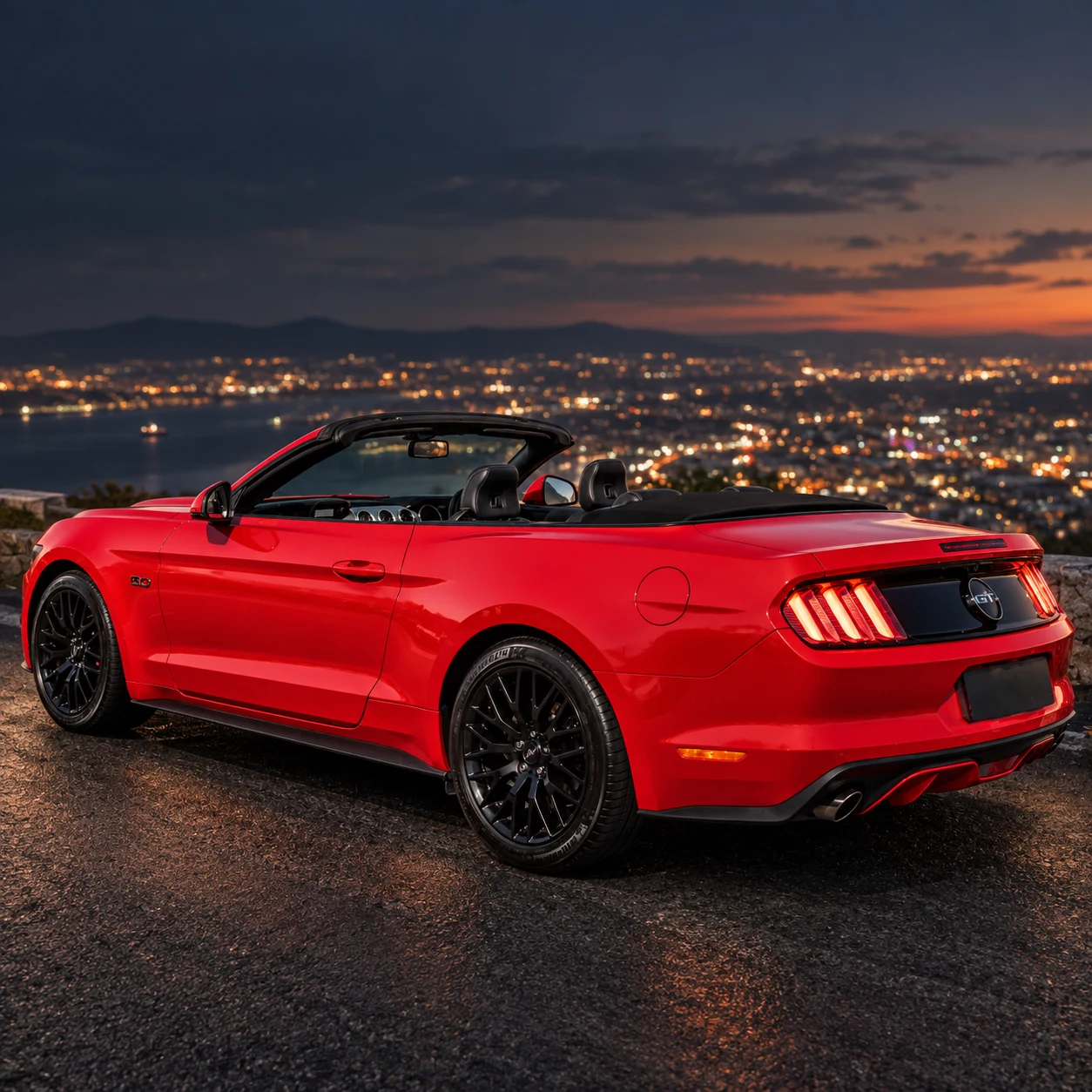 Red Ford Mustang GT Convertible with the top down, side and rear view above the city