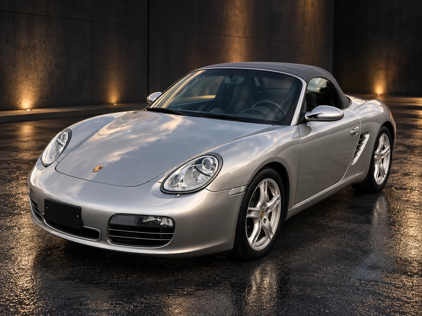 Silver Porsche Boxster with the fabric roof up, front three-quarter view